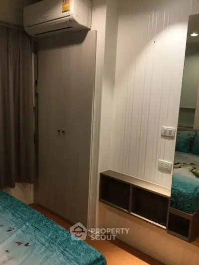 Cozy bedroom with air conditioning and built-in wardrobe, perfect for comfortable living.