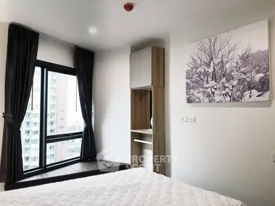 Modern bedroom with large window and stylish decor in urban apartment