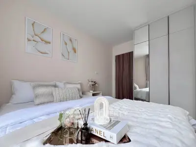 Elegant bedroom with modern decor and stylish furnishings, featuring a cozy bed and sleek wardrobe.