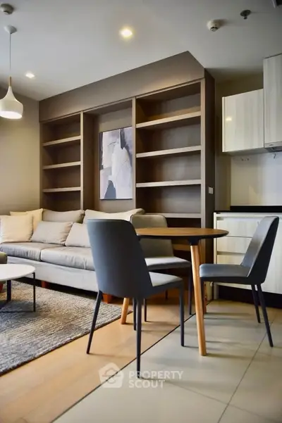 Modern living room with stylish furniture and built-in shelves, perfect for urban living.