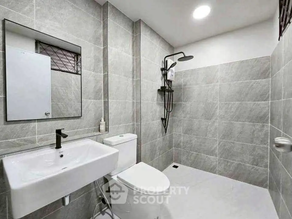 Modern bathroom with sleek fixtures and gray tile design