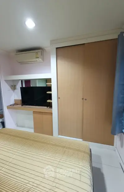 Cozy bedroom with built-in wardrobe and air conditioning unit
