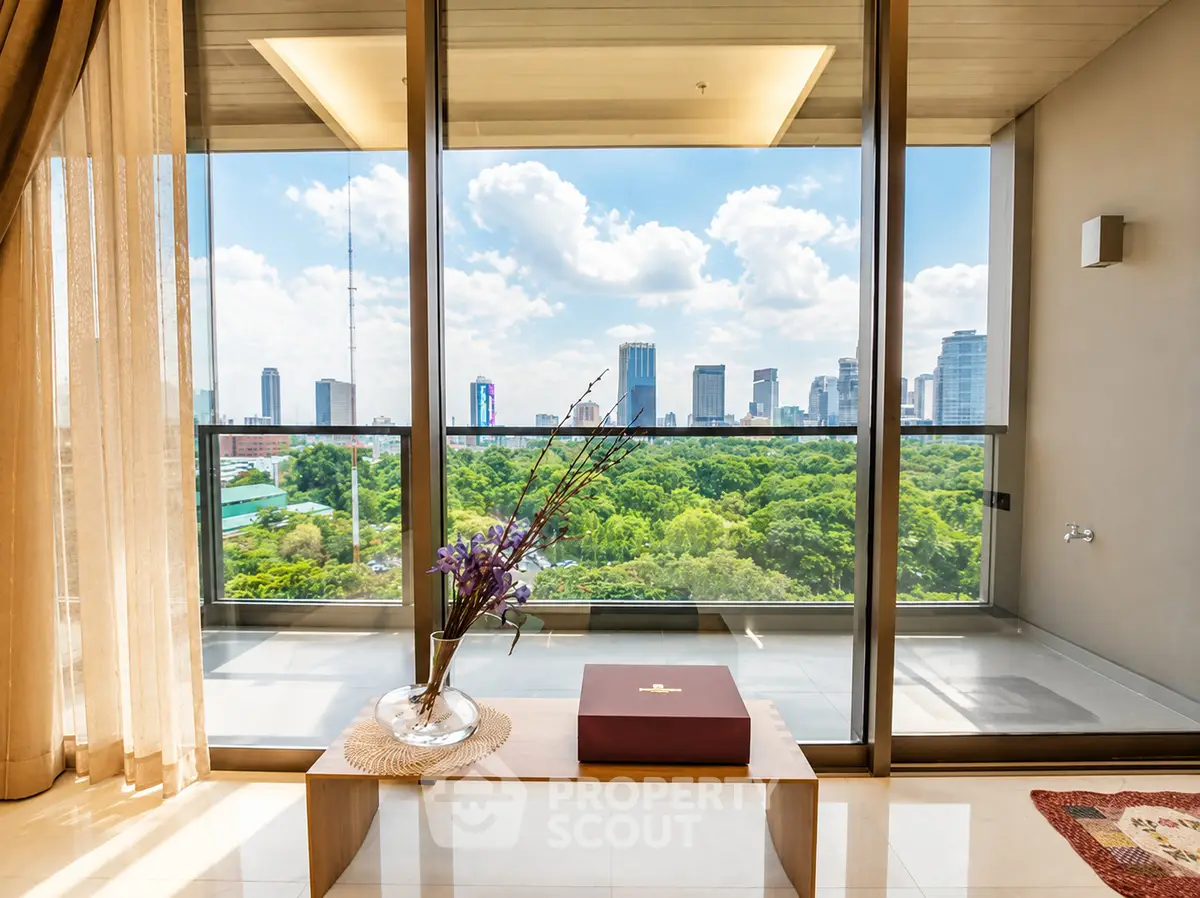 Luxurious apartment with stunning city skyline and park view from spacious balcony.