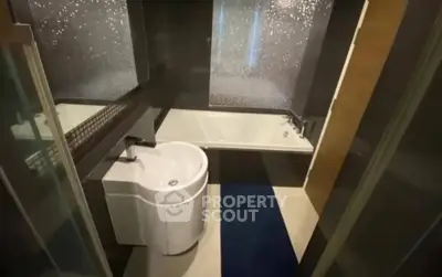 Modern bathroom with sleek design and bathtub, perfect for relaxation.