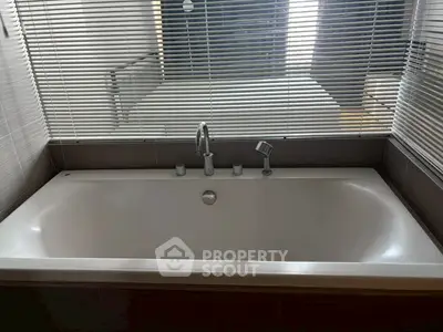 Luxurious bathroom with modern bathtub and sleek blinds