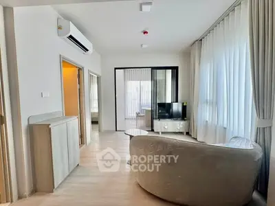 Modern living room with sleek furniture and natural light in a stylish apartment.