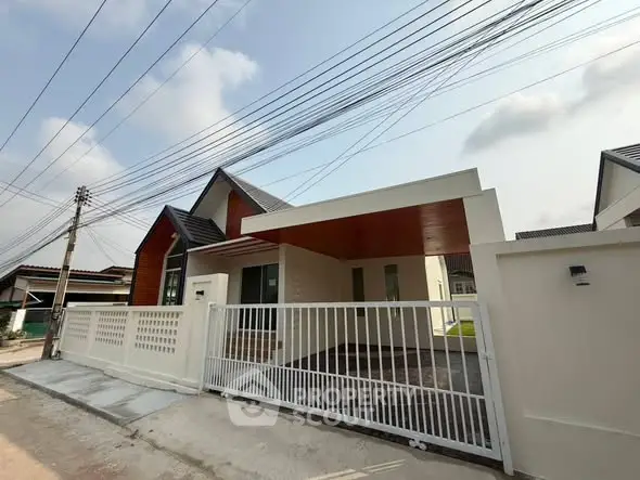 Modern single-story house with gated entrance and carport in suburban neighborhood.