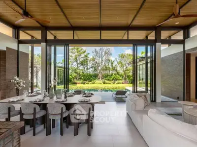 Luxurious open-plan living room with pool view and elegant dining area