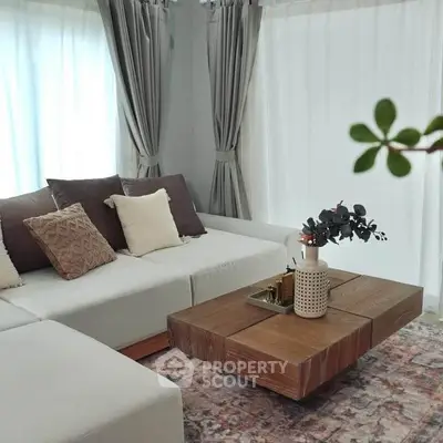 Stylish living room with modern sectional sofa and wooden coffee table, perfect for cozy gatherings.