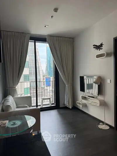 Modern living room with balcony and city view, featuring sleek furniture and floor-to-ceiling windows.