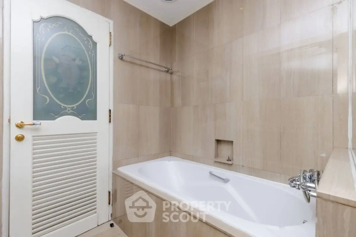 Elegant bathroom with luxurious bathtub and stylish door design