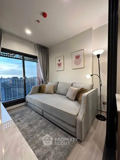 Modern living room with cozy sofa and stunning city view from large window.