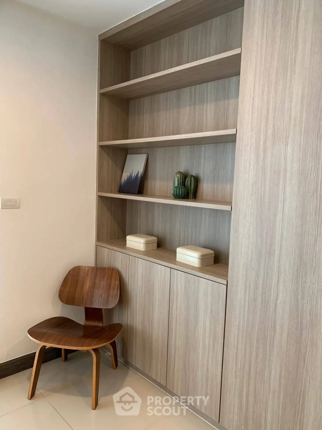 Modern minimalist study nook with wooden shelves and stylish chair