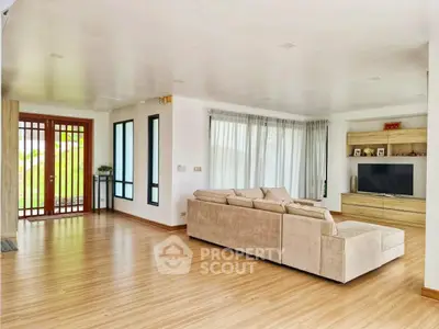 Spacious modern living room with large windows and cozy sectional sofa