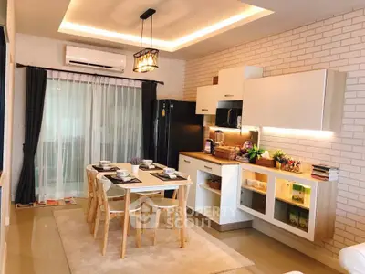 Modern kitchen with dining area, stylish lighting, and sleek cabinetry