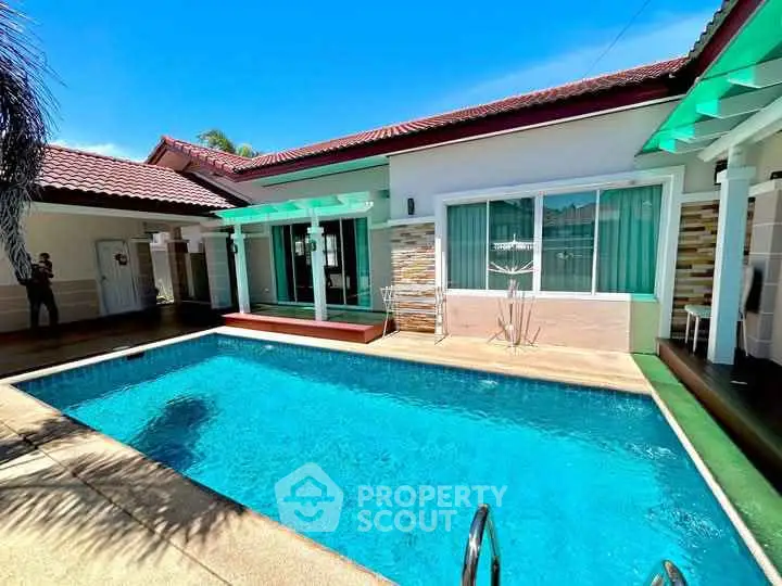 Stunning villa with private pool and modern exterior design under clear blue skies.