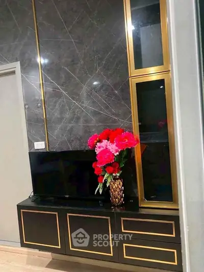 Elegant living room with modern TV stand and decorative flowers