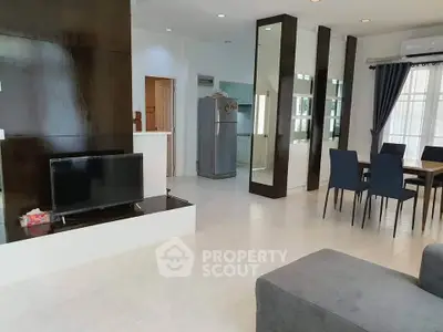 Modern open-plan living and dining area with sleek furniture and natural light.
