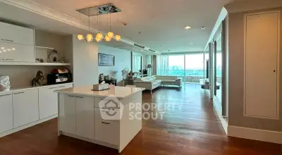 Spacious modern living room with open kitchen and stunning city view.