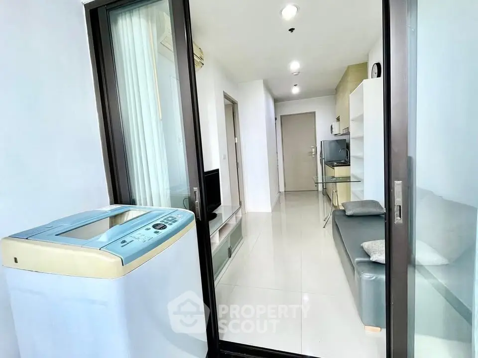 Modern apartment interior with washing machine and sleek living area