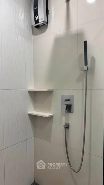 Modern bathroom shower area with sleek fixtures and elegant tile design.