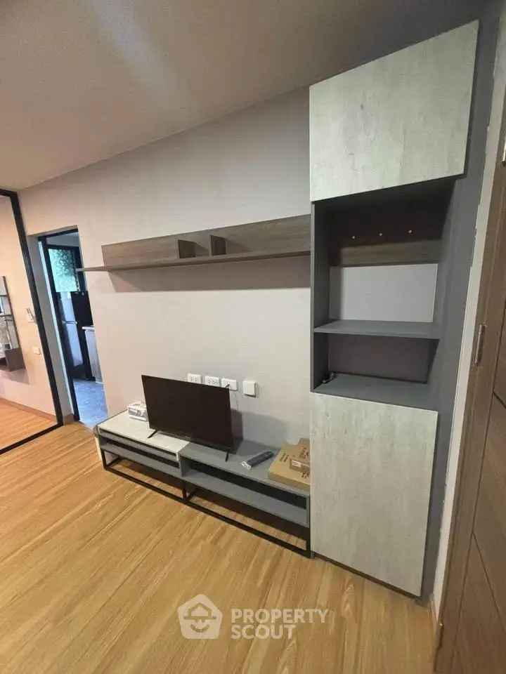 Modern living room with sleek TV stand and wooden flooring, perfect for contemporary living.