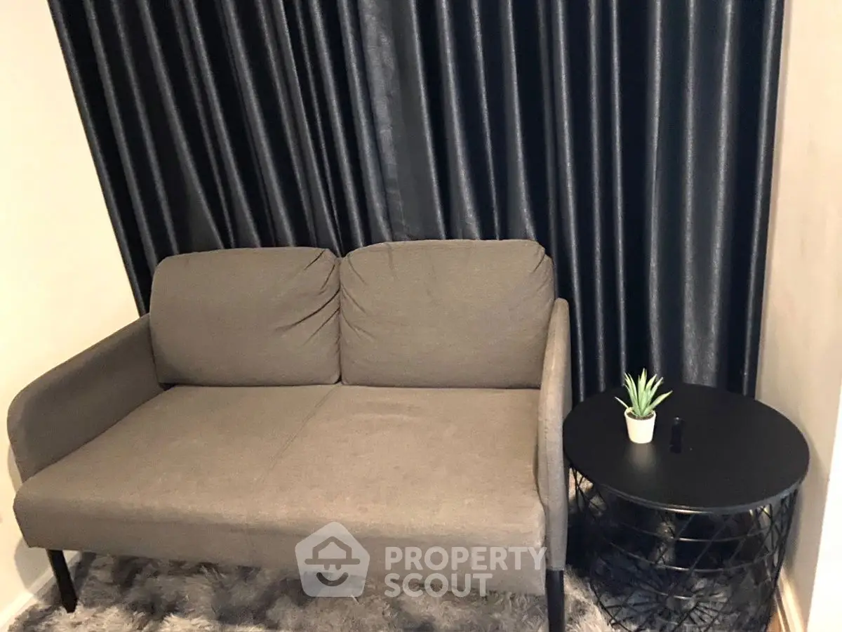 Cozy living room with modern gray sofa and stylish side table.