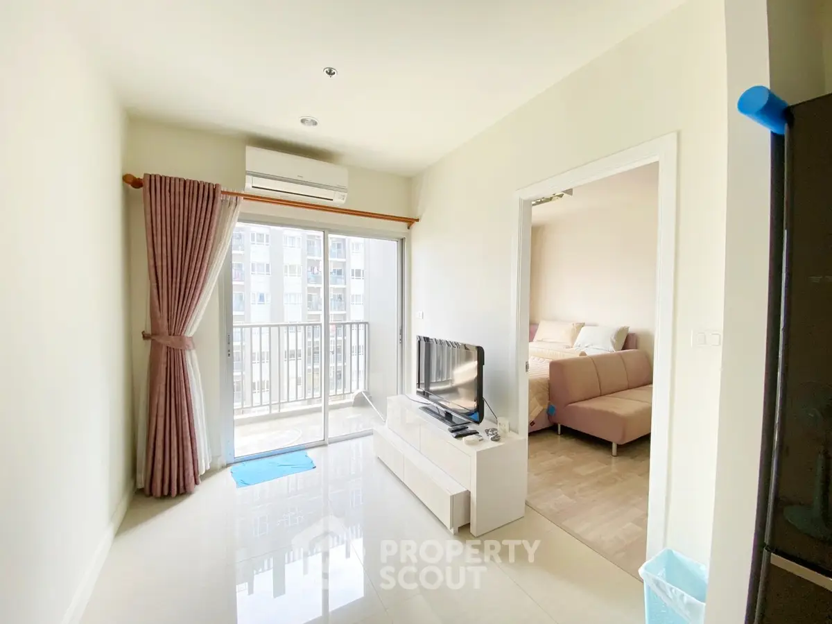 Bright living room with balcony access and modern decor in a stylish apartment.