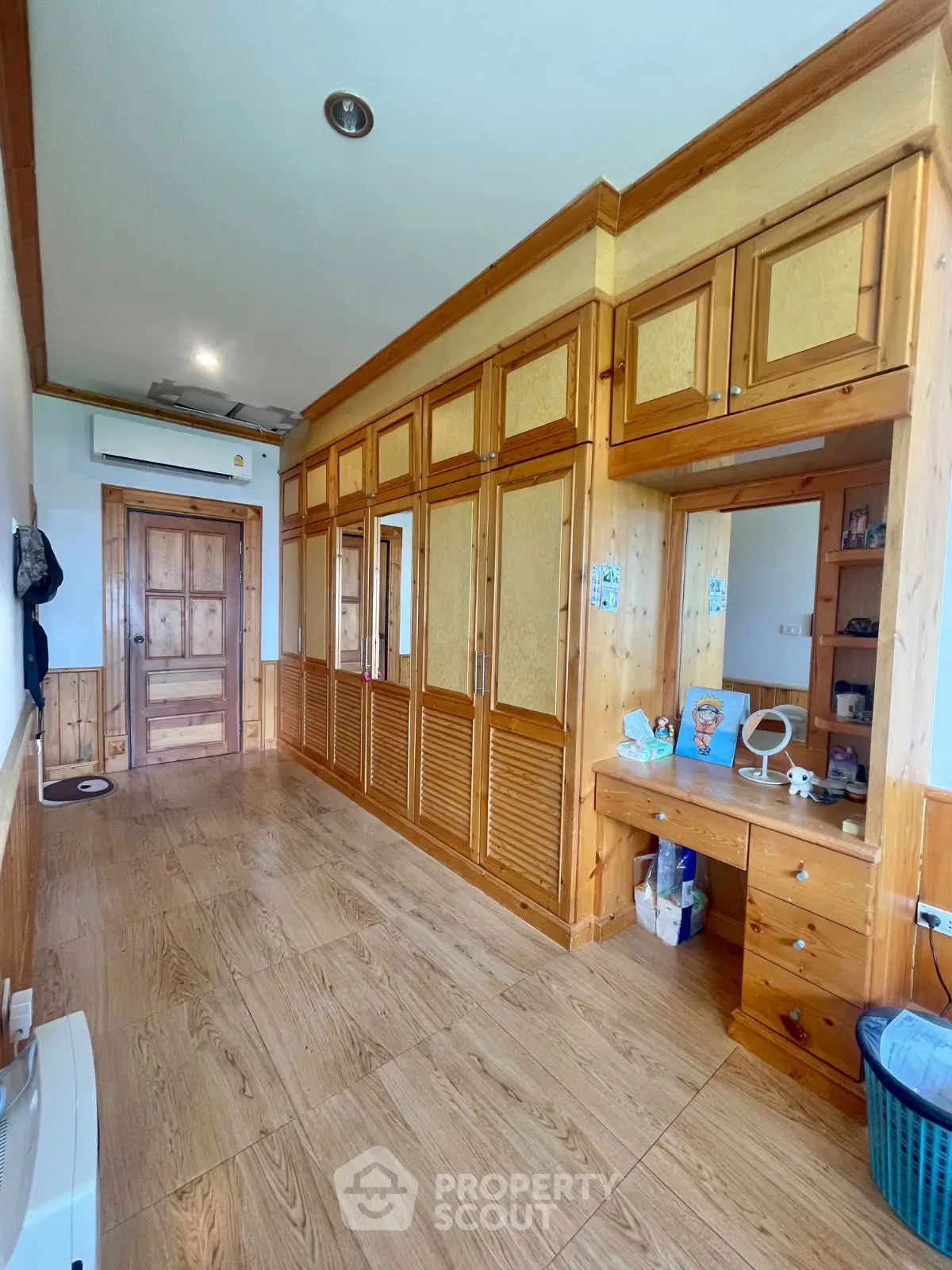 Spacious wooden wardrobe in a well-lit room with elegant decor
