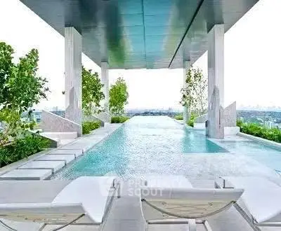 Luxurious rooftop infinity pool with stunning city views and modern lounge chairs.