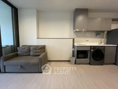 Modern apartment interior with compact kitchen and cozy living area
