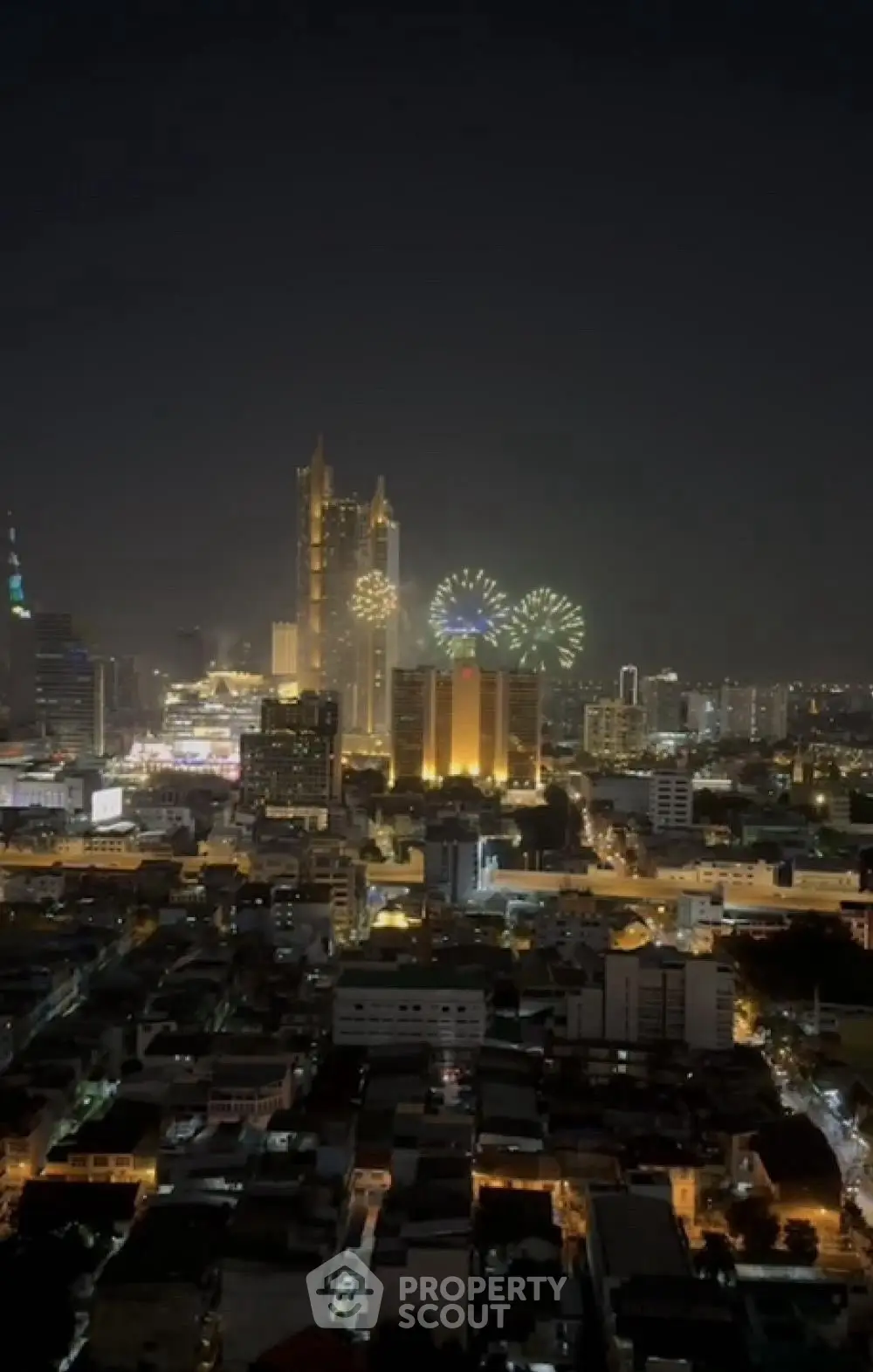 Stunning city skyline view with fireworks illuminating the night sky, perfect for urban living enthusiasts.