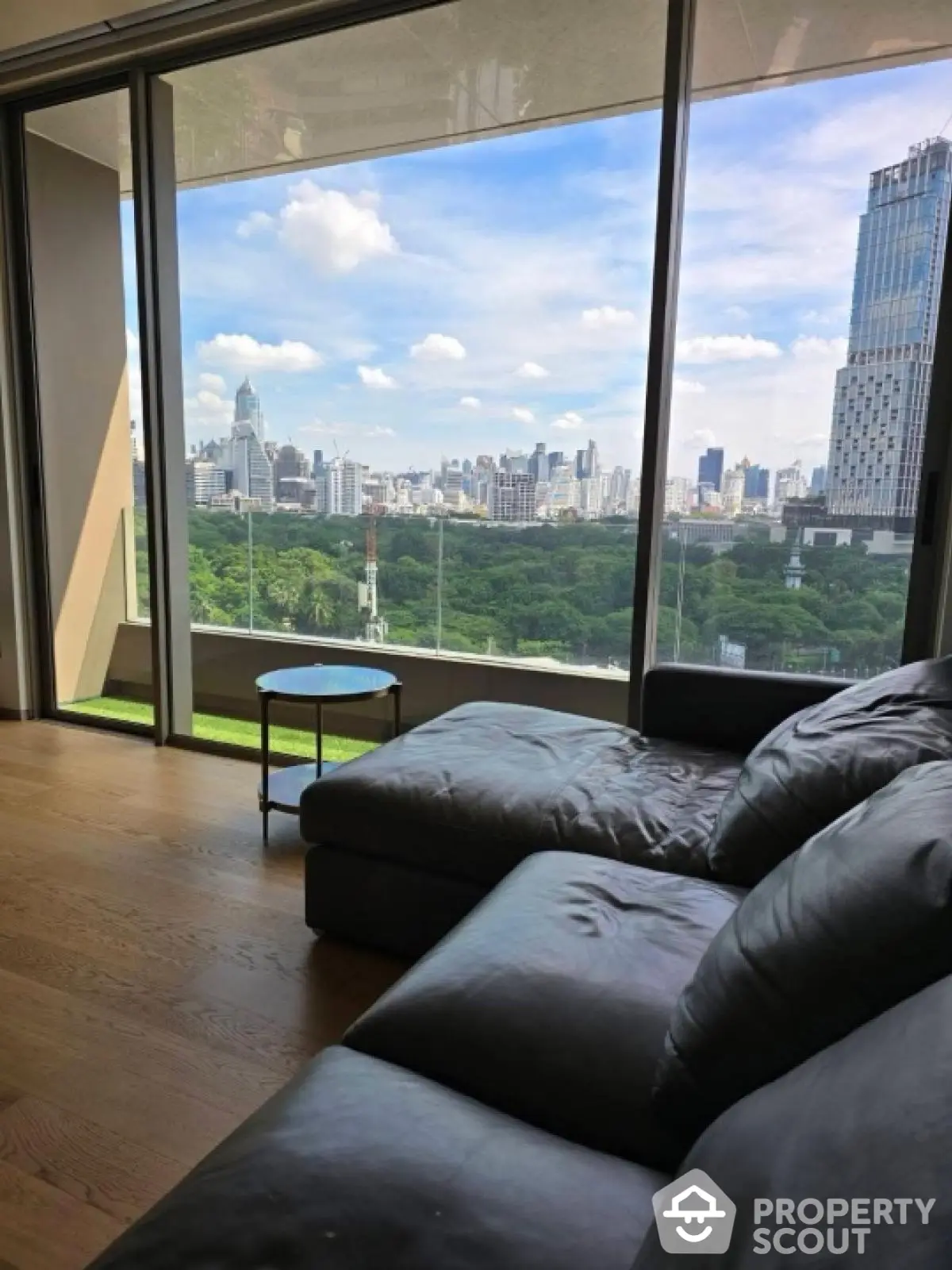 Luxurious living room with stunning city skyline view through large windows.