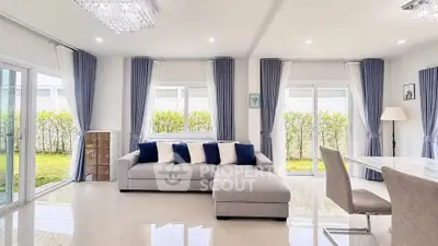 Spacious modern living room with large windows and elegant decor