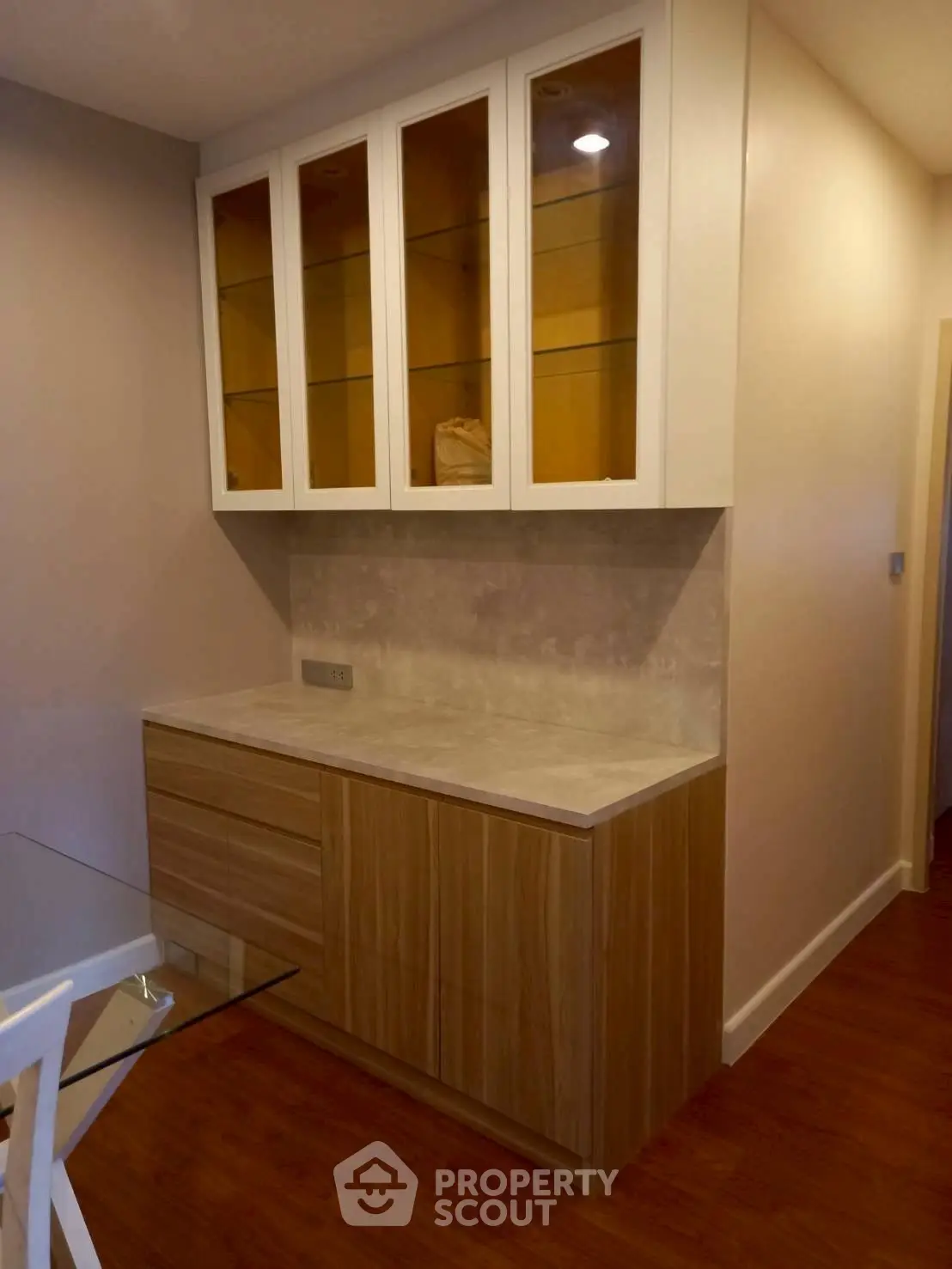 Modern kitchen with sleek cabinetry and glass display shelves