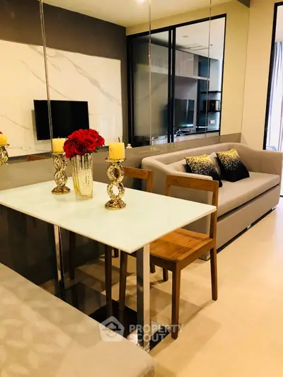 Modern living room with elegant decor and open layout, featuring a stylish dining area and cozy seating.