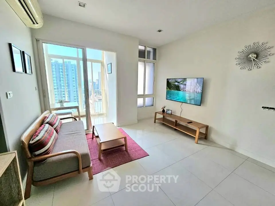 Bright living room with modern furniture and city view balcony access.
