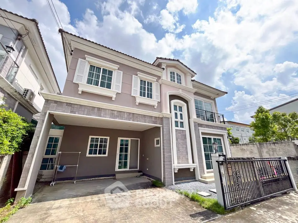 Stunning modern two-story house with spacious driveway and elegant facade under a bright blue sky.