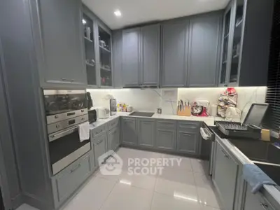 Modern kitchen with sleek cabinetry and built-in appliances in a stylish home.