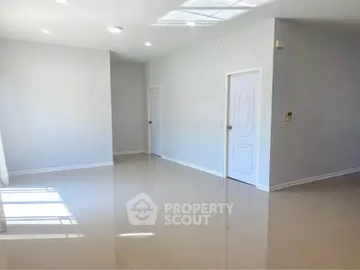 Spacious modern living room with glossy floors and elegant white doors