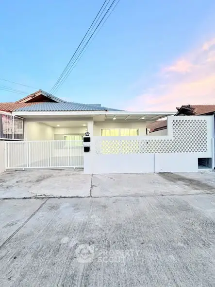 Charming single-story home with modern facade and spacious driveway, perfect for family living.