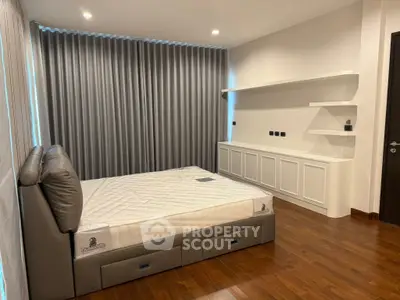 Spacious modern bedroom with sleek design and hardwood floors