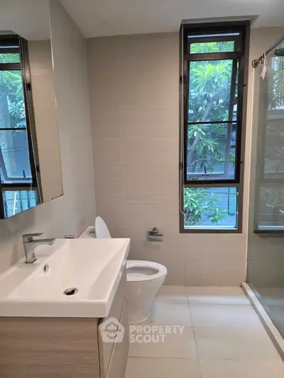Modern bathroom with large window and sleek fixtures