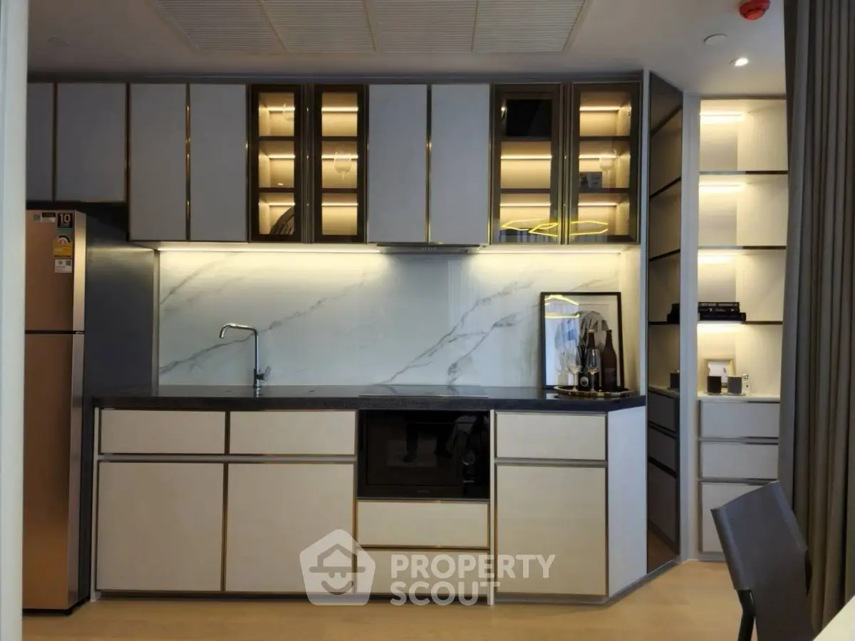 Modern kitchen with sleek cabinetry and built-in appliances