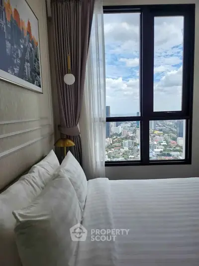 Luxurious bedroom with stunning city view from high-rise window, elegant decor and plush bedding.