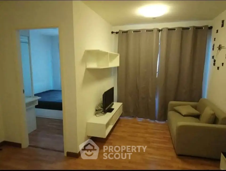 Cozy living room with modern decor and adjacent bedroom view