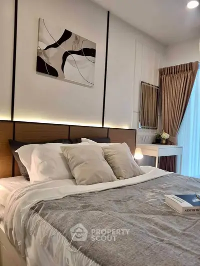 Elegant bedroom with modern decor and cozy bedding in a stylish apartment.