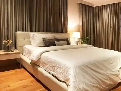 Luxurious bedroom with elegant decor and cozy ambiance, featuring a plush bed and stylish curtains.