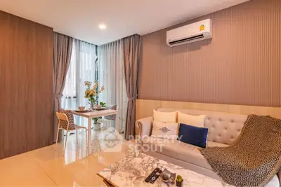 Modern living room with elegant decor and dining area, featuring a cozy sofa and air conditioning.