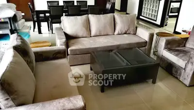 Spacious living room with plush sofas and elegant dining area, perfect for modern family living.
